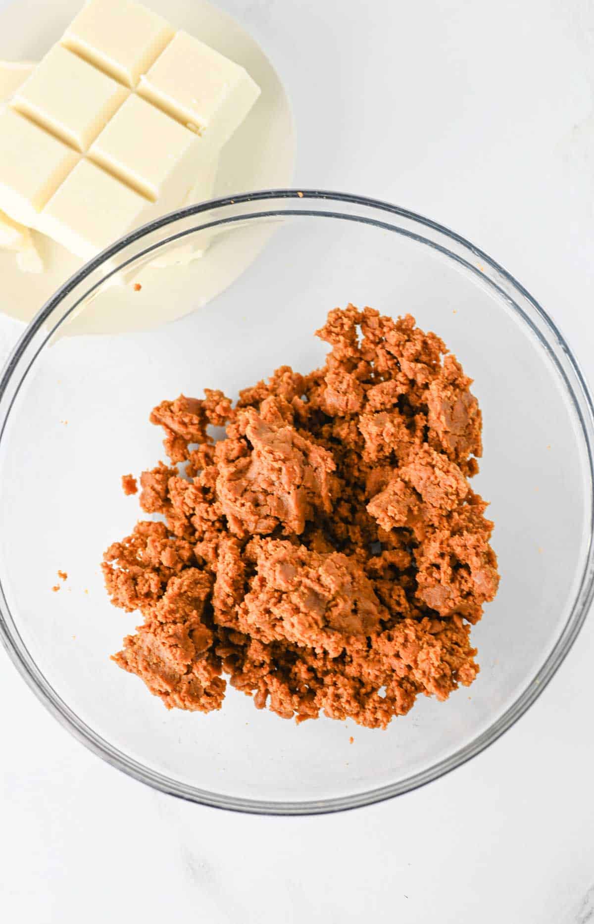 mixture of biscoff crumbs, cookie butter and cream cheese in a glass mixing bowl