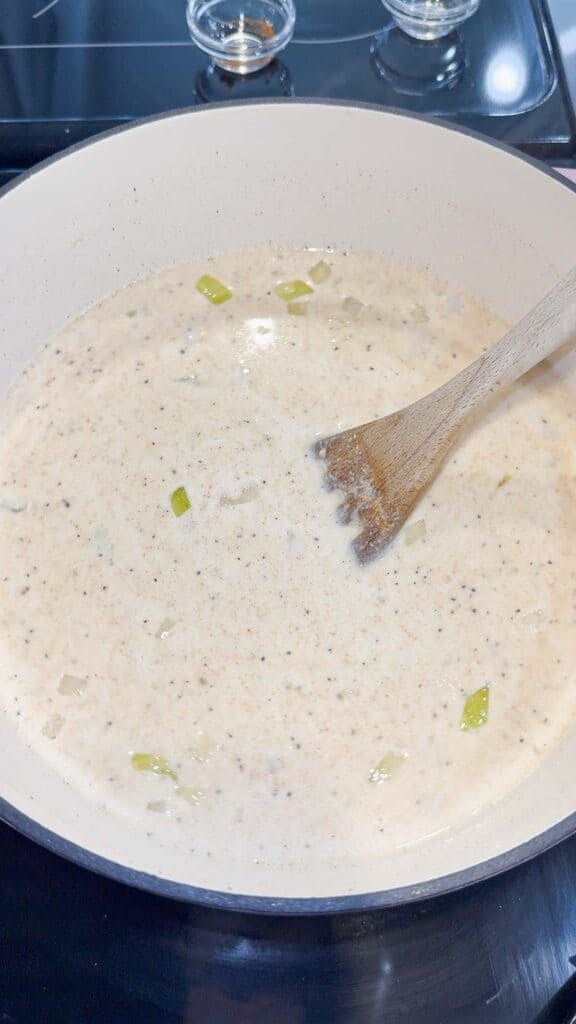 stirring half and half and spices into soup