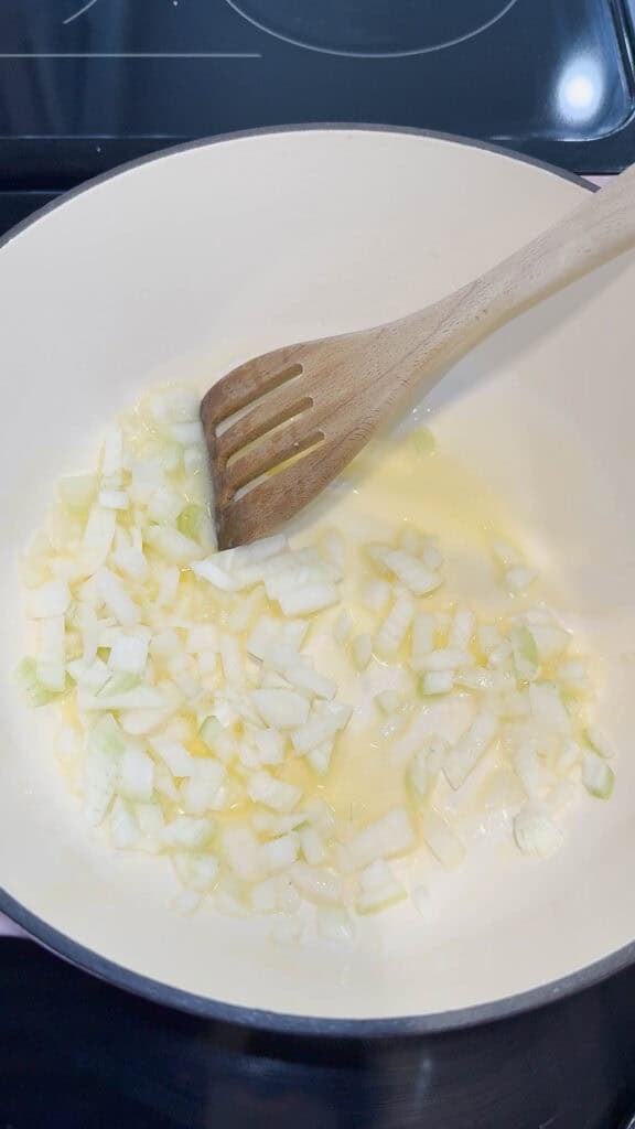 diced onions in butter cooking in a pot