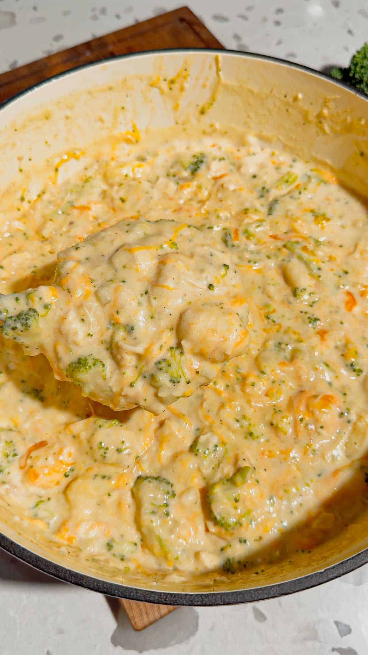broccoli cheddar chicken gnocchi soup in a pot with a ladle