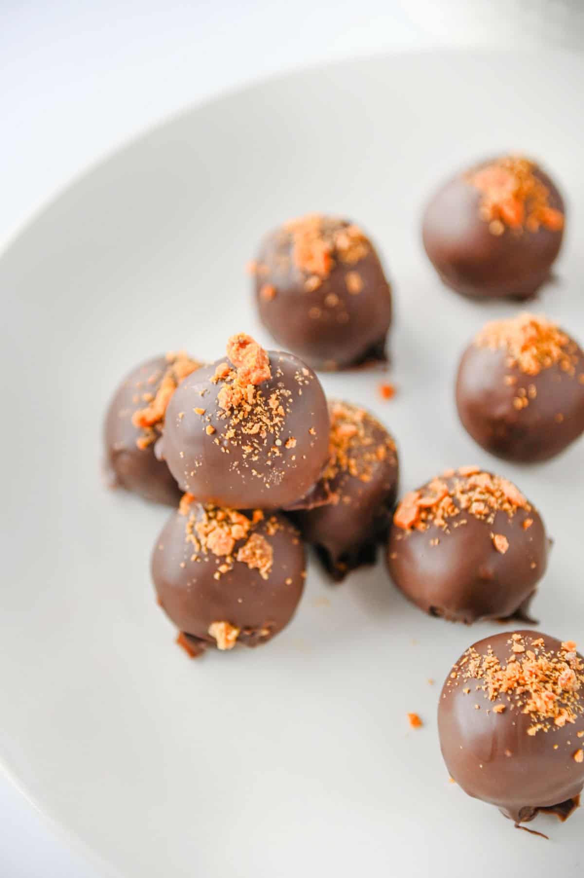 butterfinger balls stacked on a plate