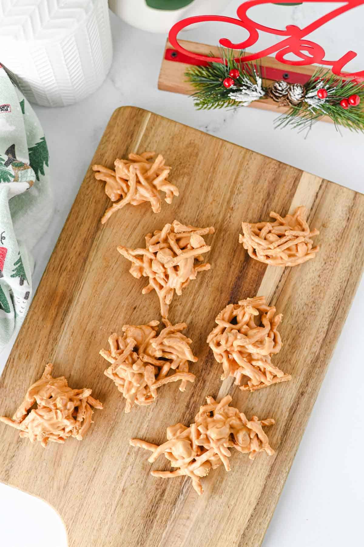 overhead of butterscotch haystacks on a wooden serving board