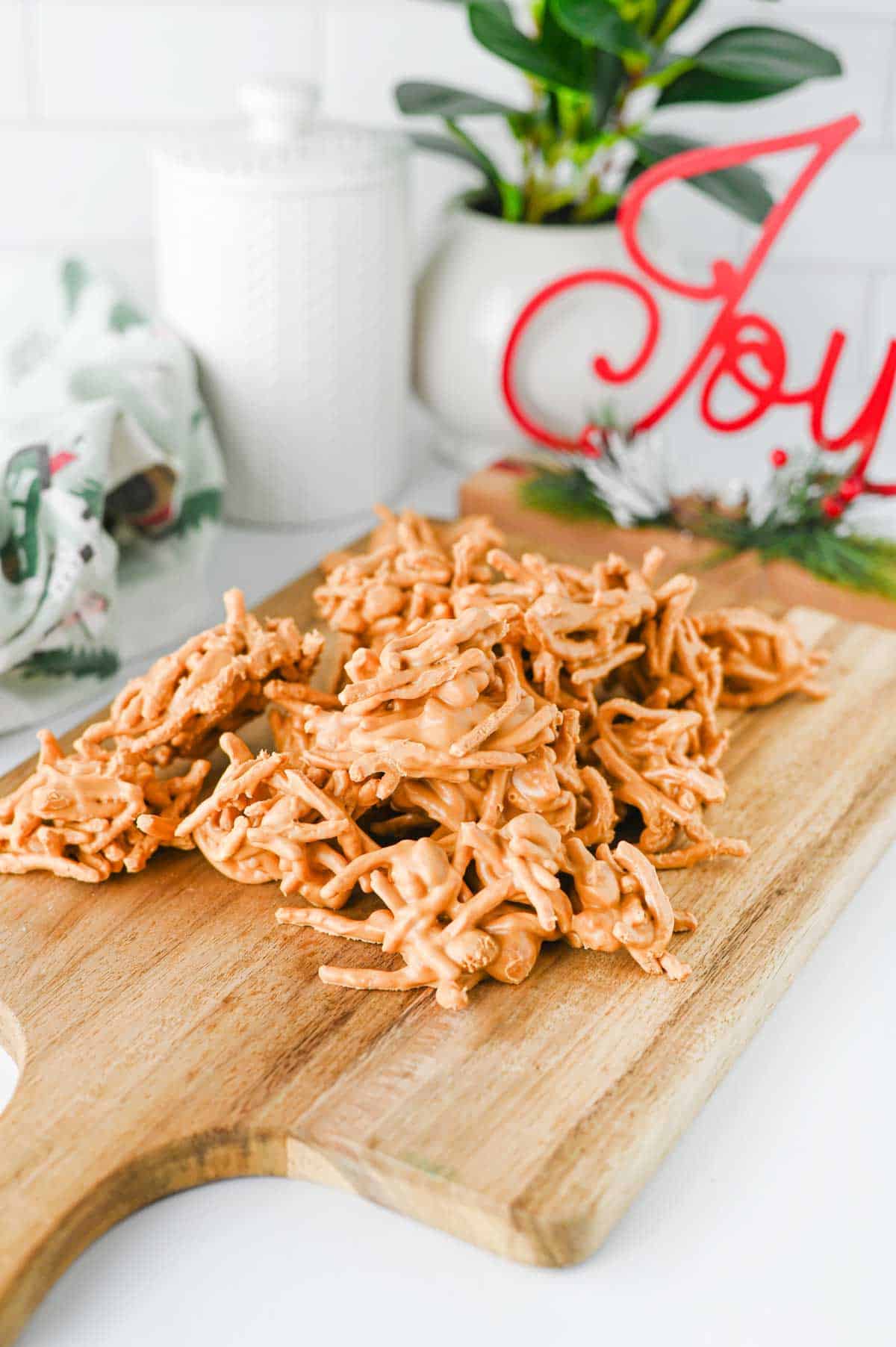 butterscotch haystacks stacked on a wooden serving board
