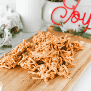 These easy Butterscotch Haystacks are the sweet and salty no bake treats your dessert tray needs! Made with butterscotch chips, creamy peanut butter, crunchy chow mein noodles, and roasted salted peanuts, this 4 ingredient haystack recipe is simple to make in the microwave. Scoop into clusters, chill until set, and enjoy homemade butterscotch candy with plenty of crunch. Perfect for Christmas candy trays, holiday desserts, cookie exchanges, edible gifts, potlucks, and easy party treats, these peanut butter butterscotch haystacks are a family friendly dessert you can make without turning on the oven. Save this easy no bake candy recipe for your Christmas baking list or whenever you need a quick dessert with just a handful of ingredients!