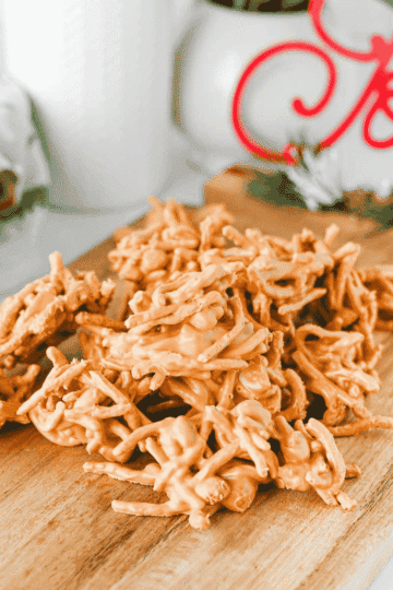 These easy Butterscotch Haystacks are the sweet and salty no bake treats your dessert tray needs! Made with butterscotch chips, creamy peanut butter, crunchy chow mein noodles, and roasted salted peanuts, this 4 ingredient haystack recipe is simple to make in the microwave. Scoop into clusters, chill until set, and enjoy homemade butterscotch candy with plenty of crunch. Perfect for Christmas candy trays, holiday desserts, cookie exchanges, edible gifts, potlucks, and easy party treats, these peanut butter butterscotch haystacks are a family friendly dessert you can make without turning on the oven. Save this easy no bake candy recipe for your Christmas baking list or whenever you need a quick dessert with just a handful of ingredients!