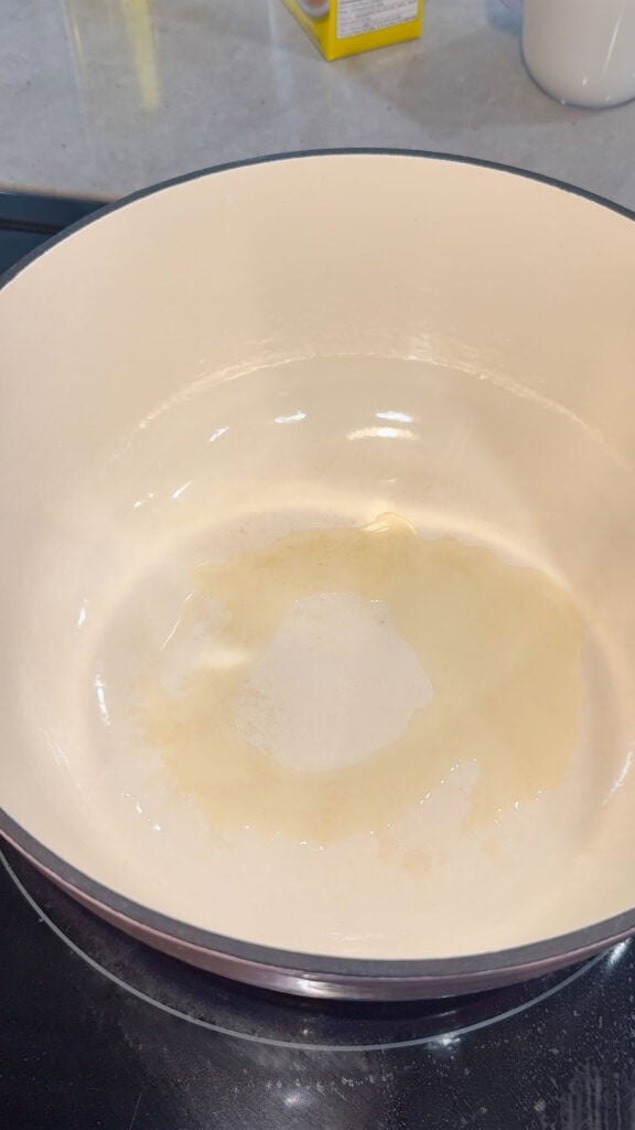 olive oil heating in a dutch oven