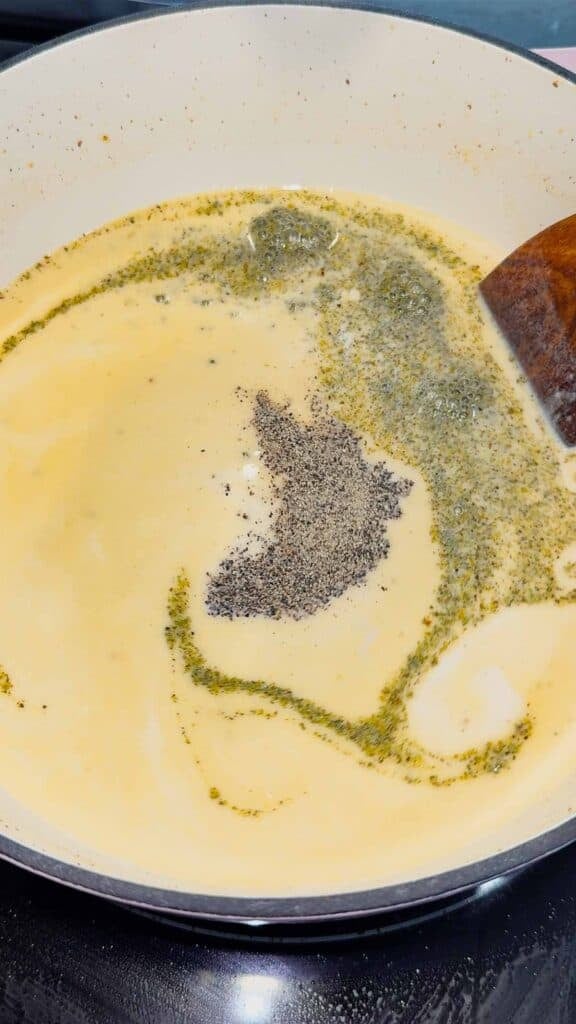italian seasoning, salt and pepper added to cream soup in a pot