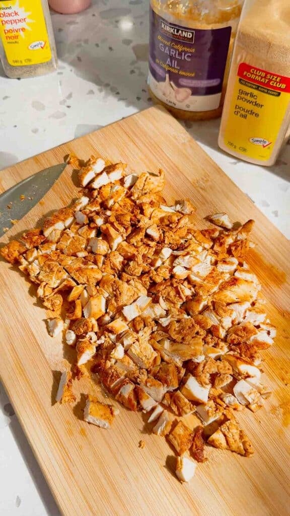 chopped seasoned chicken breast on a cutting board