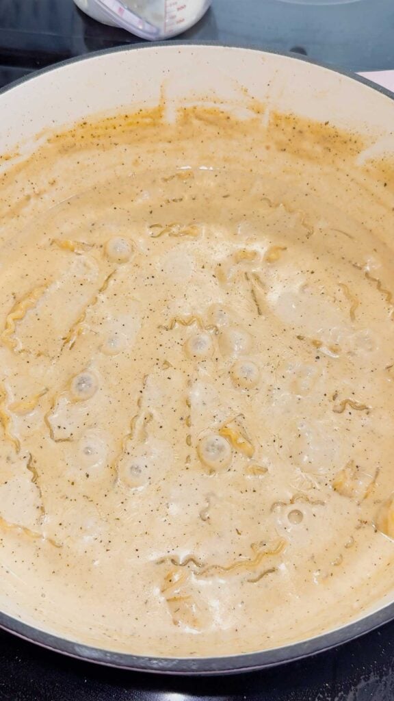 creamy noodle soup simmering in a pot