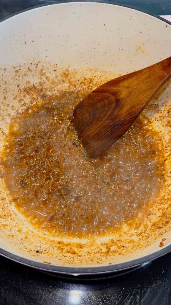 stirring melted butter and chopped garlic in a dutch oven