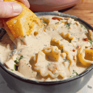 Chicken Alfredo Lasagna Soup is the creamy comfort food dinner your family will request again and again! This easy chicken soup recipe combines seasoned chicken breast, tender pasta, garlic, Parmesan cheese and mozzarella in a rich, creamy Alfredo inspired broth. Ready in just 40 minutes, this hearty pasta soup is perfect for busy weeknight dinners, chilly evenings and family meals. If you love chicken Alfredo pasta, white chicken lasagna or creamy chicken noodle soup, save this cheesy soup recipe for your dinner rotation. Top each bowl with crispy bacon and fresh parsley, then serve with garlic bread for the ultimate comfort food meal. This Chicken Alfredo Lasagna Soup recipe brings big flavor to a deliciously easy homemade dinner!