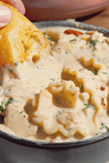 Chicken Alfredo Lasagna Soup is the creamy comfort food dinner your family will request again and again! This easy chicken soup recipe combines seasoned chicken breast, tender pasta, garlic, Parmesan cheese and mozzarella in a rich, creamy Alfredo inspired broth. Ready in just 40 minutes, this hearty pasta soup is perfect for busy weeknight dinners, chilly evenings and family meals. If you love chicken Alfredo pasta, white chicken lasagna or creamy chicken noodle soup, save this cheesy soup recipe for your dinner rotation. Top each bowl with crispy bacon and fresh parsley, then serve with garlic bread for the ultimate comfort food meal. This Chicken Alfredo Lasagna Soup recipe brings big flavor to a deliciously easy homemade dinner!
