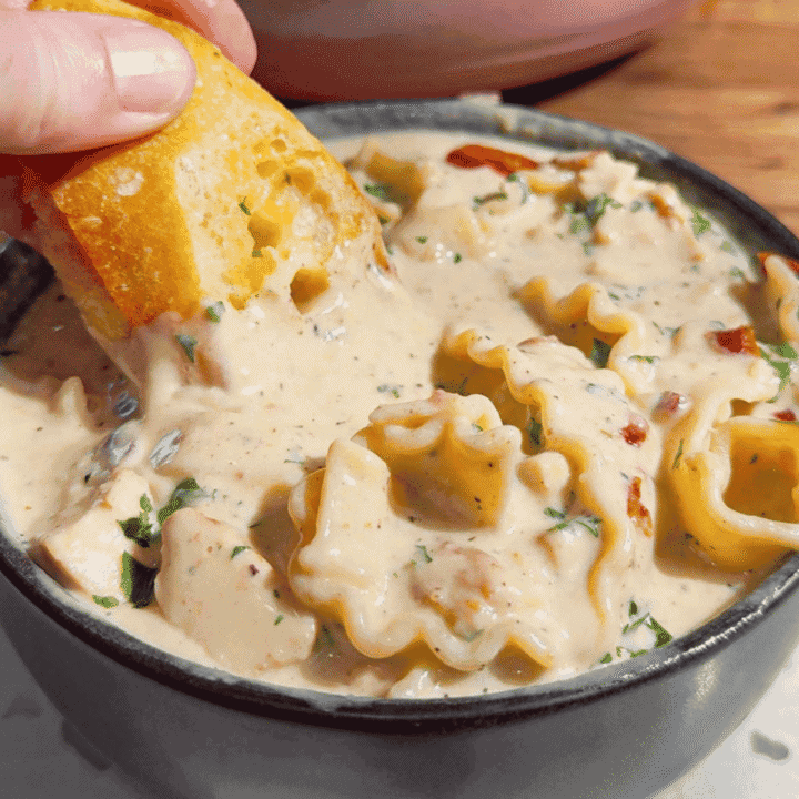 Chicken Alfredo Lasagna Soup is the creamy comfort food dinner your family will request again and again! This easy chicken soup recipe combines seasoned chicken breast, tender pasta, garlic, Parmesan cheese and mozzarella in a rich, creamy Alfredo inspired broth. Ready in just 40 minutes, this hearty pasta soup is perfect for busy weeknight dinners, chilly evenings and family meals. If you love chicken Alfredo pasta, white chicken lasagna or creamy chicken noodle soup, save this cheesy soup recipe for your dinner rotation. Top each bowl with crispy bacon and fresh parsley, then serve with garlic bread for the ultimate comfort food meal. This Chicken Alfredo Lasagna Soup recipe brings big flavor to a deliciously easy homemade dinner!