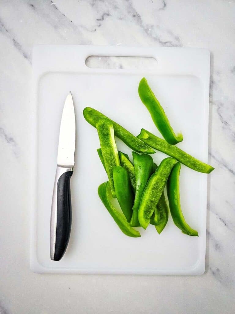 sliced green peppers on a cutting board