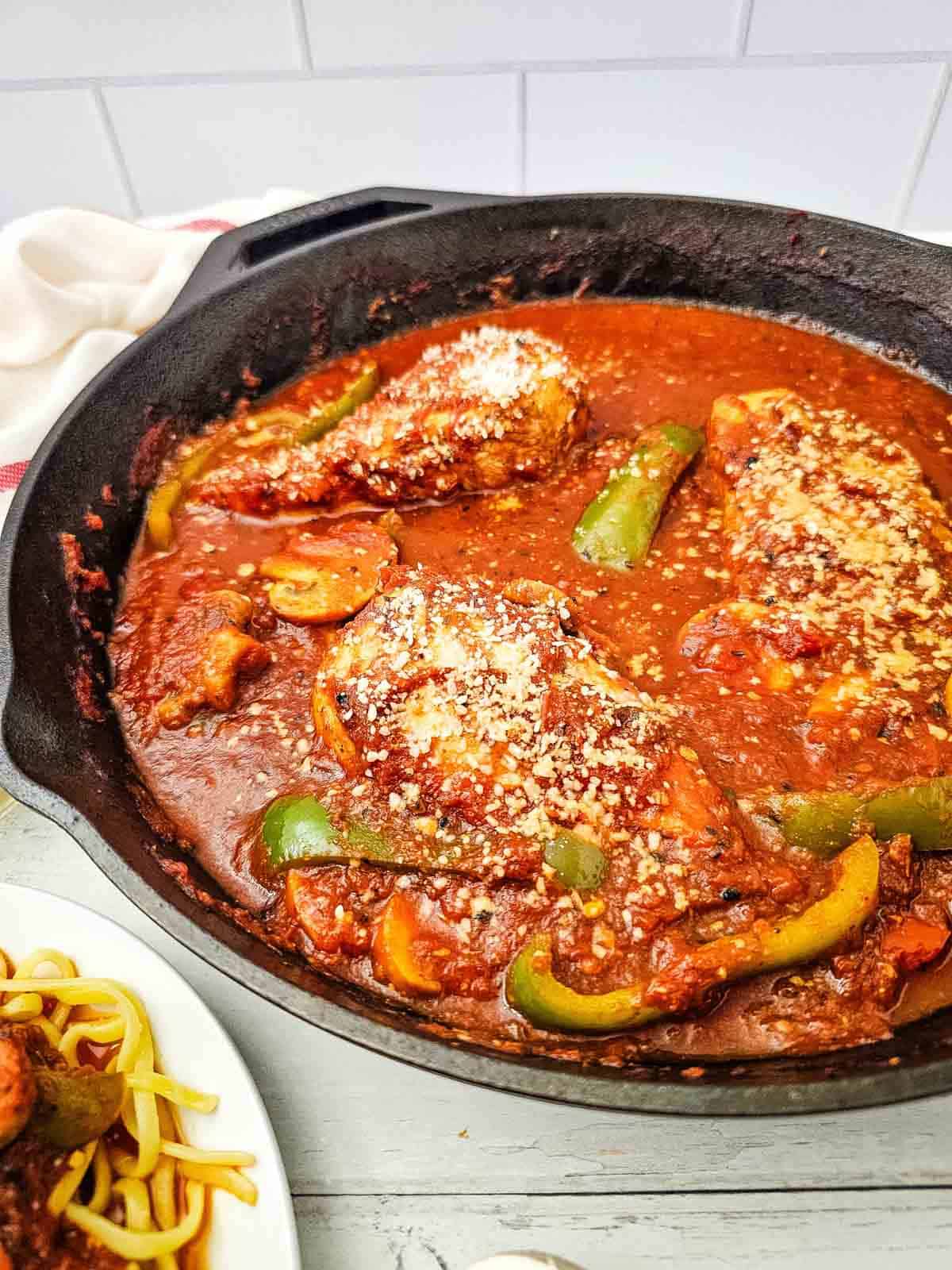 chicken cacciatore in a skillet on the counter