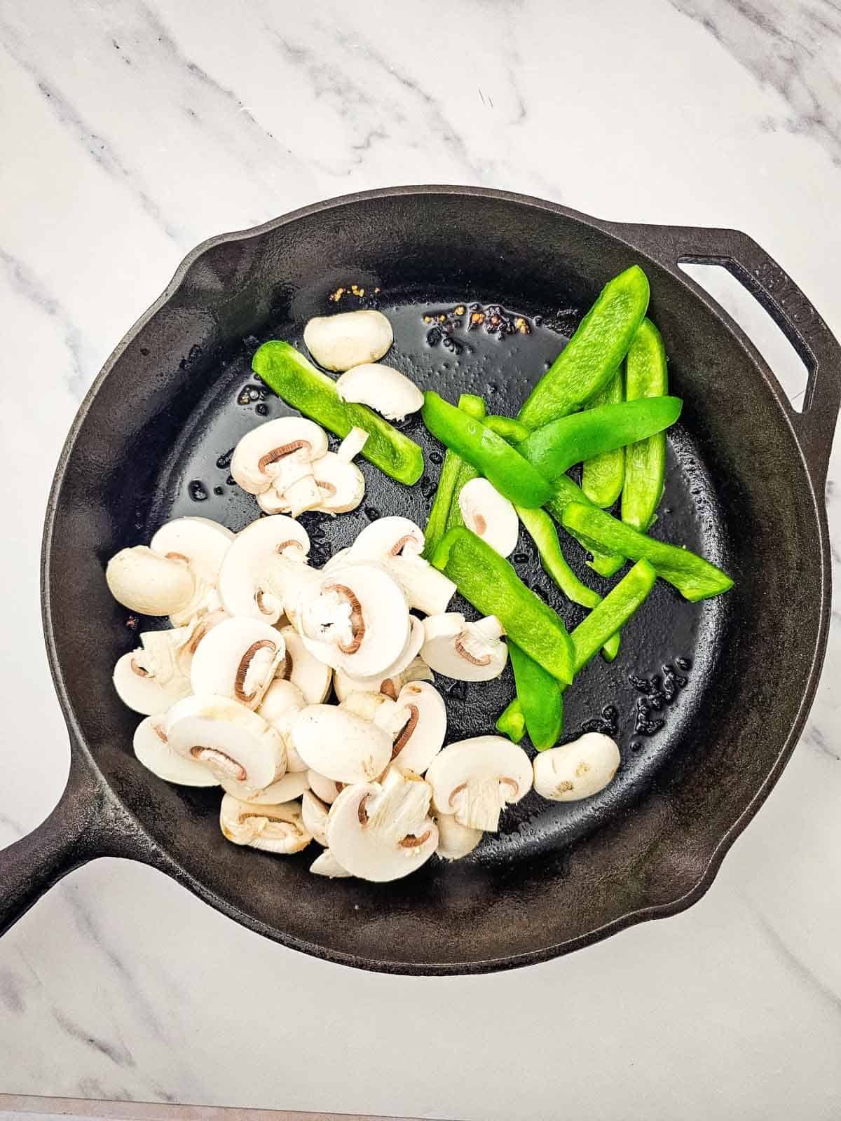 green peppers and mushrooms in a skillet