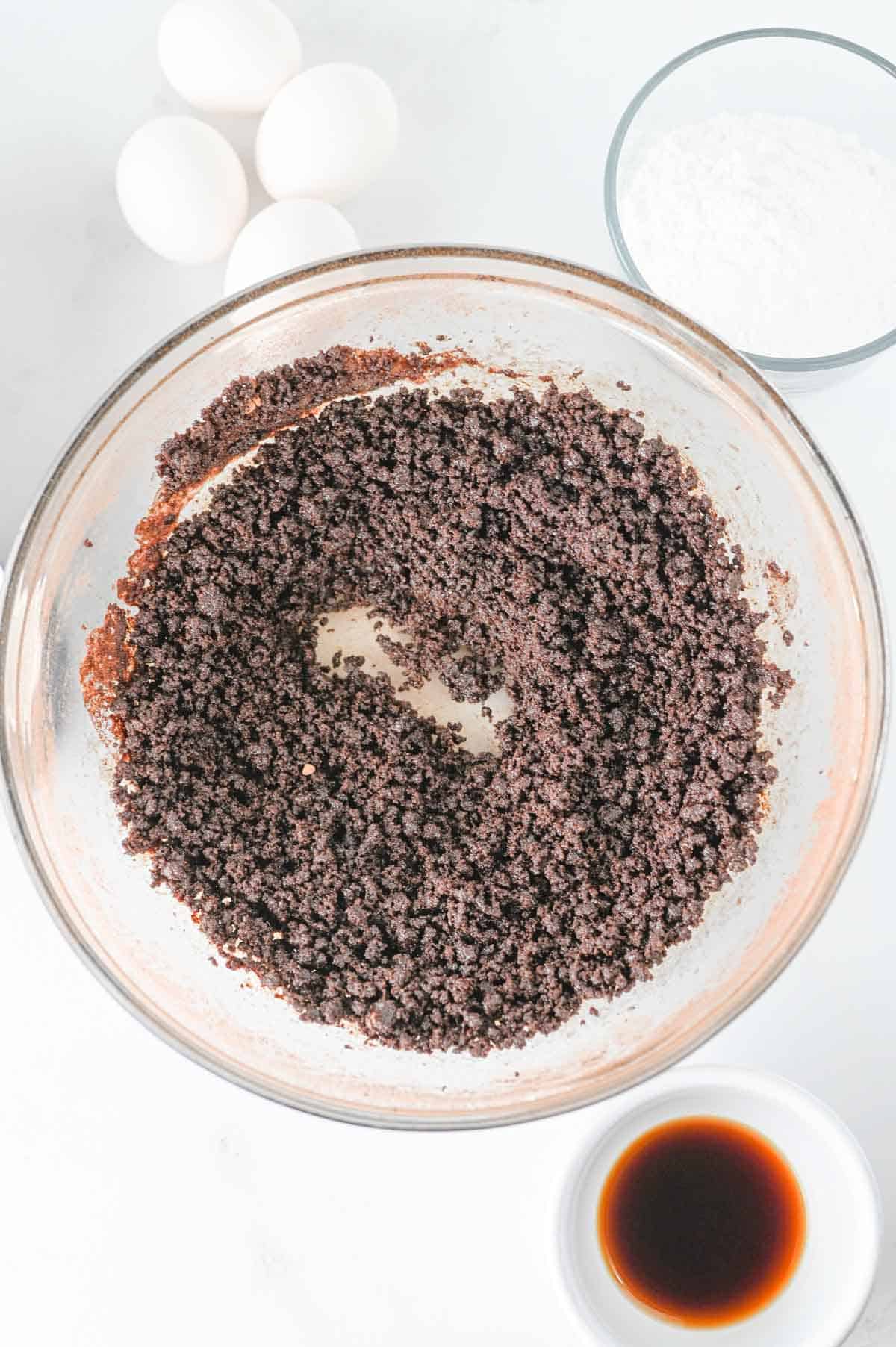 cocoa powder, sugar and oil combined in a mixing bowl