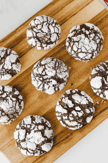 These Chocolate Crinkle Cookies are rich, fudgy, and rolled in powdered sugar for that classic crackled holiday cookie look. Made with cocoa powder, granulated sugar, oil, eggs, vanilla, flour, baking powder, salt, and powdered sugar, this easy chocolate cookie recipe chills overnight so the dough bakes up soft, chewy, and deeply chocolatey. Perfect for Christmas cookie trays, holiday baking, cookie exchanges, dessert platters, bake sales, homemade food gifts, or cozy weekend treats, these homemade chocolate crinkles are simple to make and always look bakery-worthy. Save this recipe for easy Christmas cookies, fudgy chocolate cookies, powdered sugar cookies, make ahead cookie dough, chocolate Christmas cookies, and holiday desserts everyone will grab first.