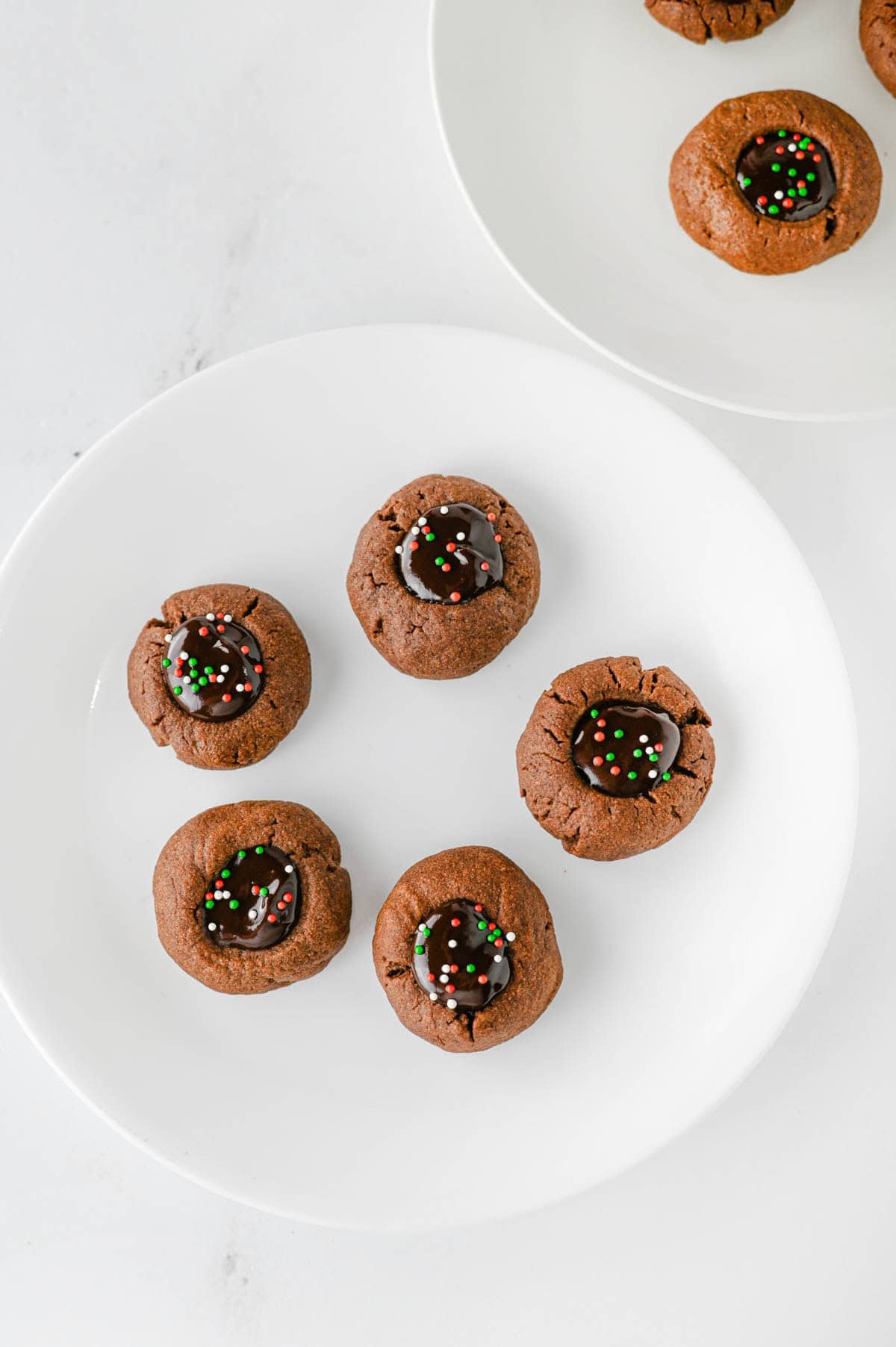 overhead of chocolate thumbprint cookies on aplate