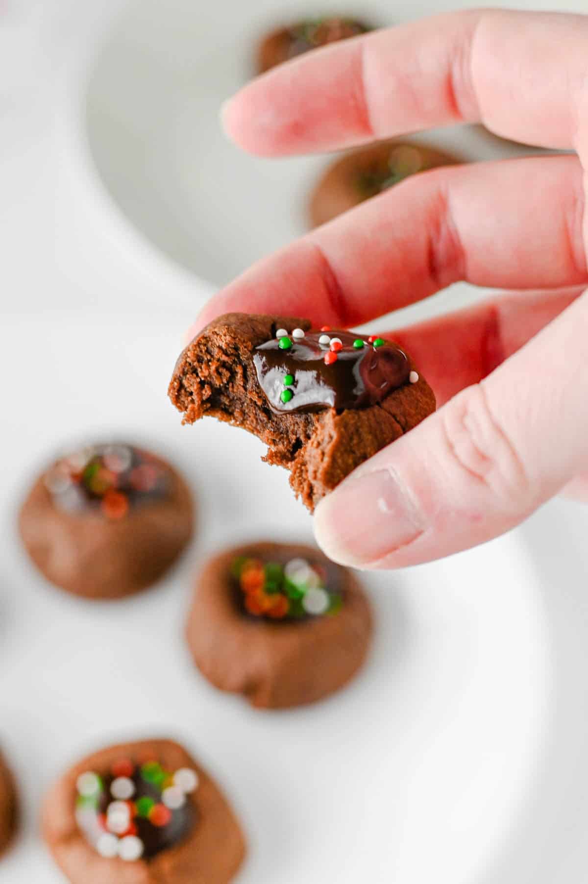 bite taken out of chocolate thumbprint cookie