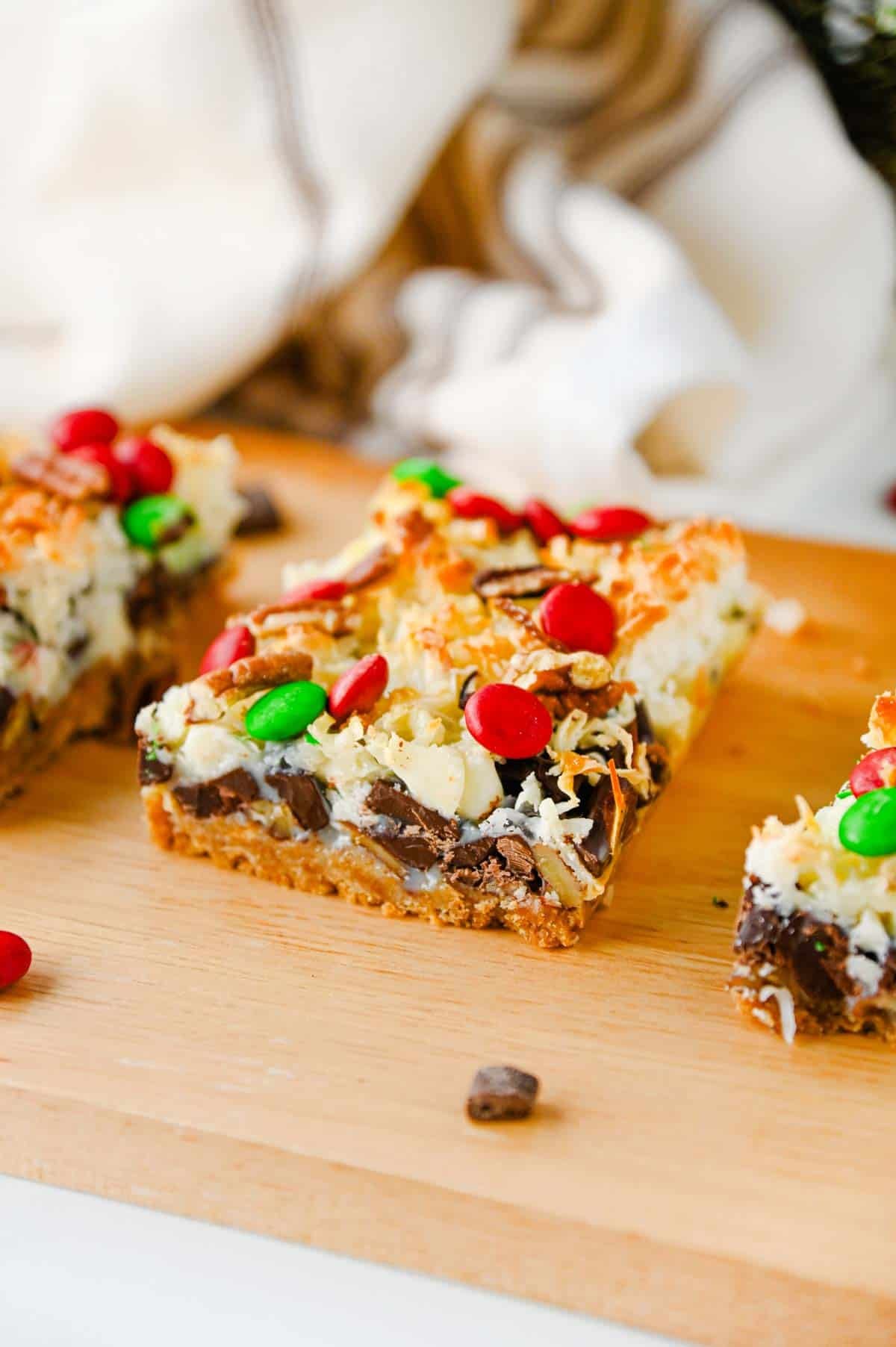 christmas magic cookier bars on a wooden serving board