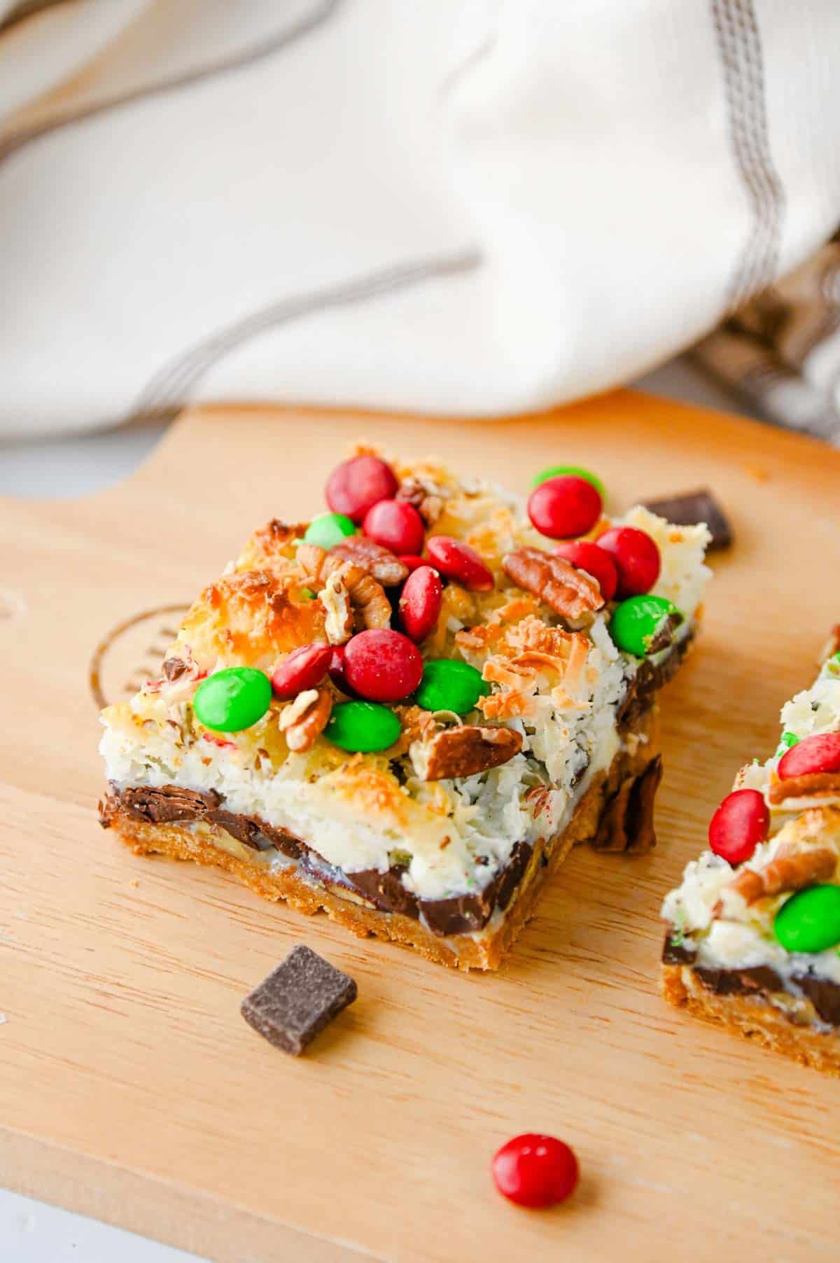 christmas 7 layer cookie bar on a serving board