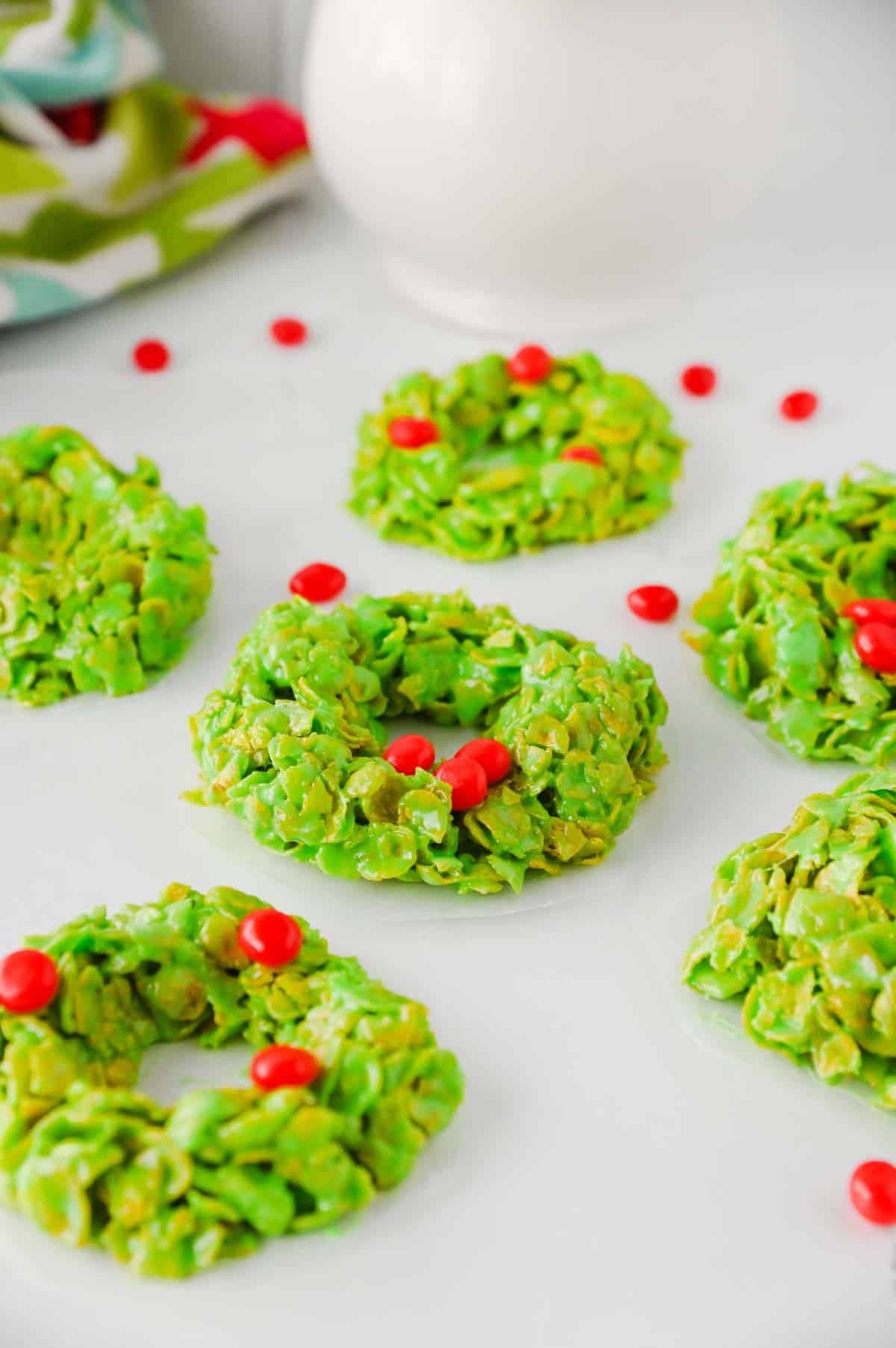 rings of green cornflake mixture topped with red candies