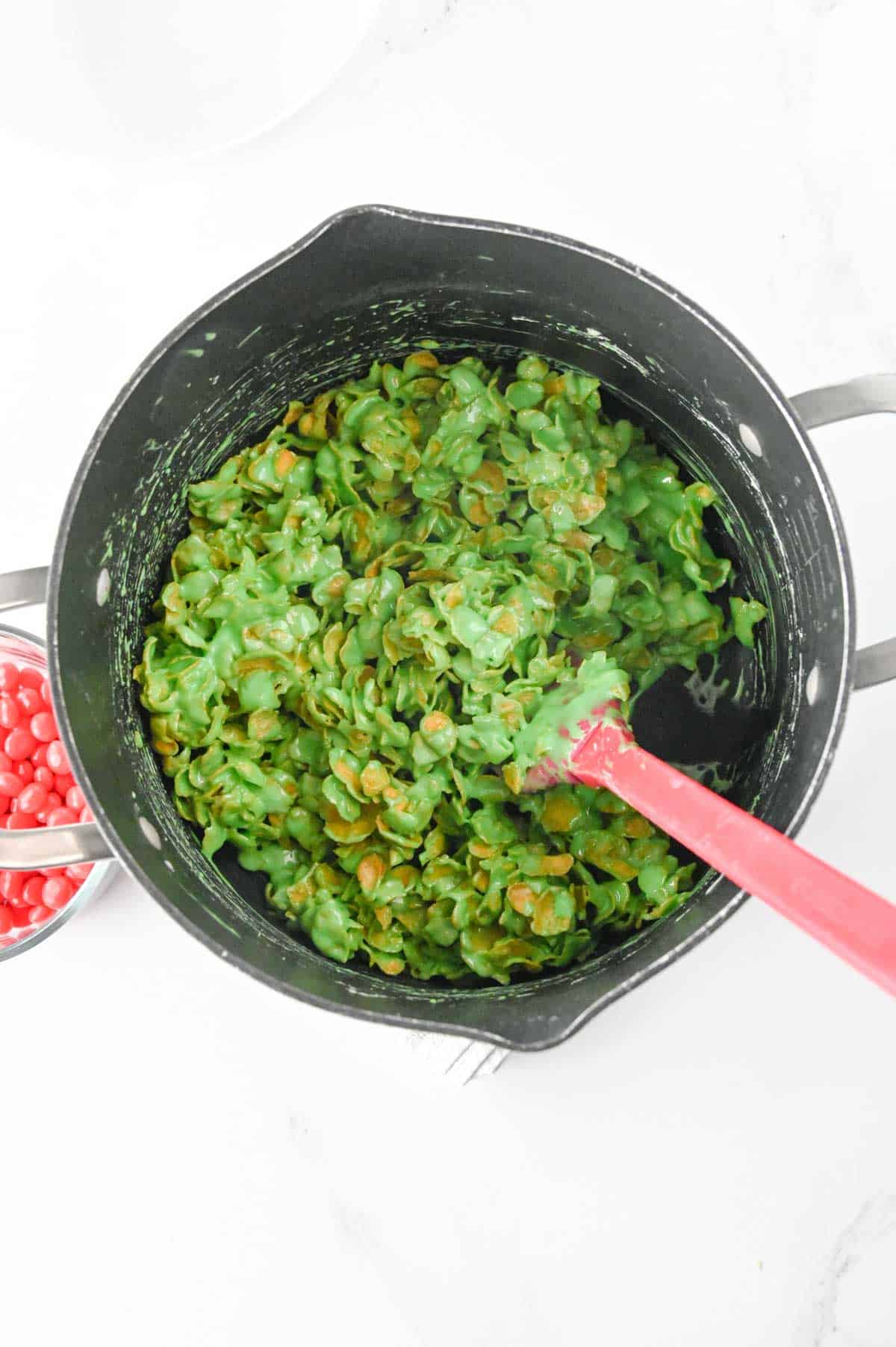 green marshmallow and cornflake mixture in a pot