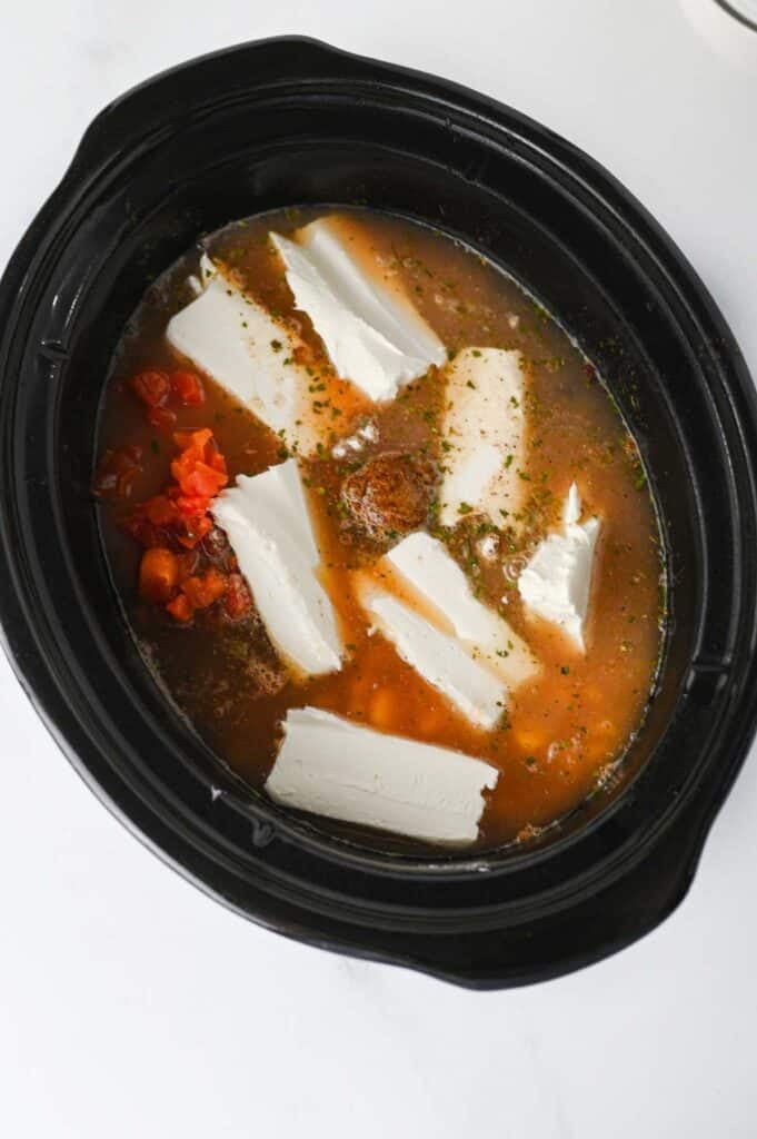 cream cheese, borth and other ingredients in a crock pot
