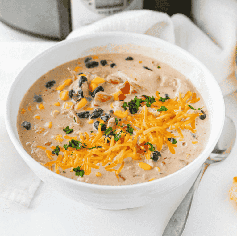 This Cream Cheese Chicken Chili is an easy crock pot dinner made with tender shredded chicken, black beans, corn, diced tomatoes, ranch seasoning, chicken broth, warm spices and cream cheese for the perfect creamy finish. This slow cooker chicken chili is rich, hearty and packed with flavor, making it a cozy weeknight dinner, game day meal or simple family comfort food recipe. Serve this creamy chicken chili with shredded cheese, cilantro, tortilla chips or over rice for a filling bowl everyone will love. If you need easy slow cooker recipes, crock pot chicken recipes, creamy chili recipes or simple dinner ideas with chicken thighs or chicken breasts, this Cream Cheese Chicken Chili is a must try.