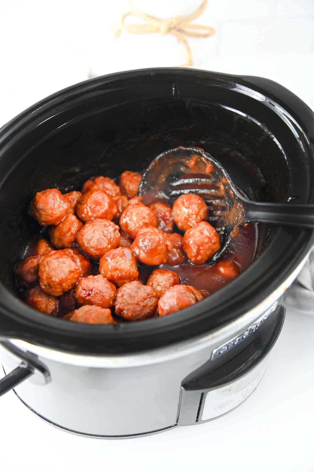 cranberry meatballs cooking in a slow cooker