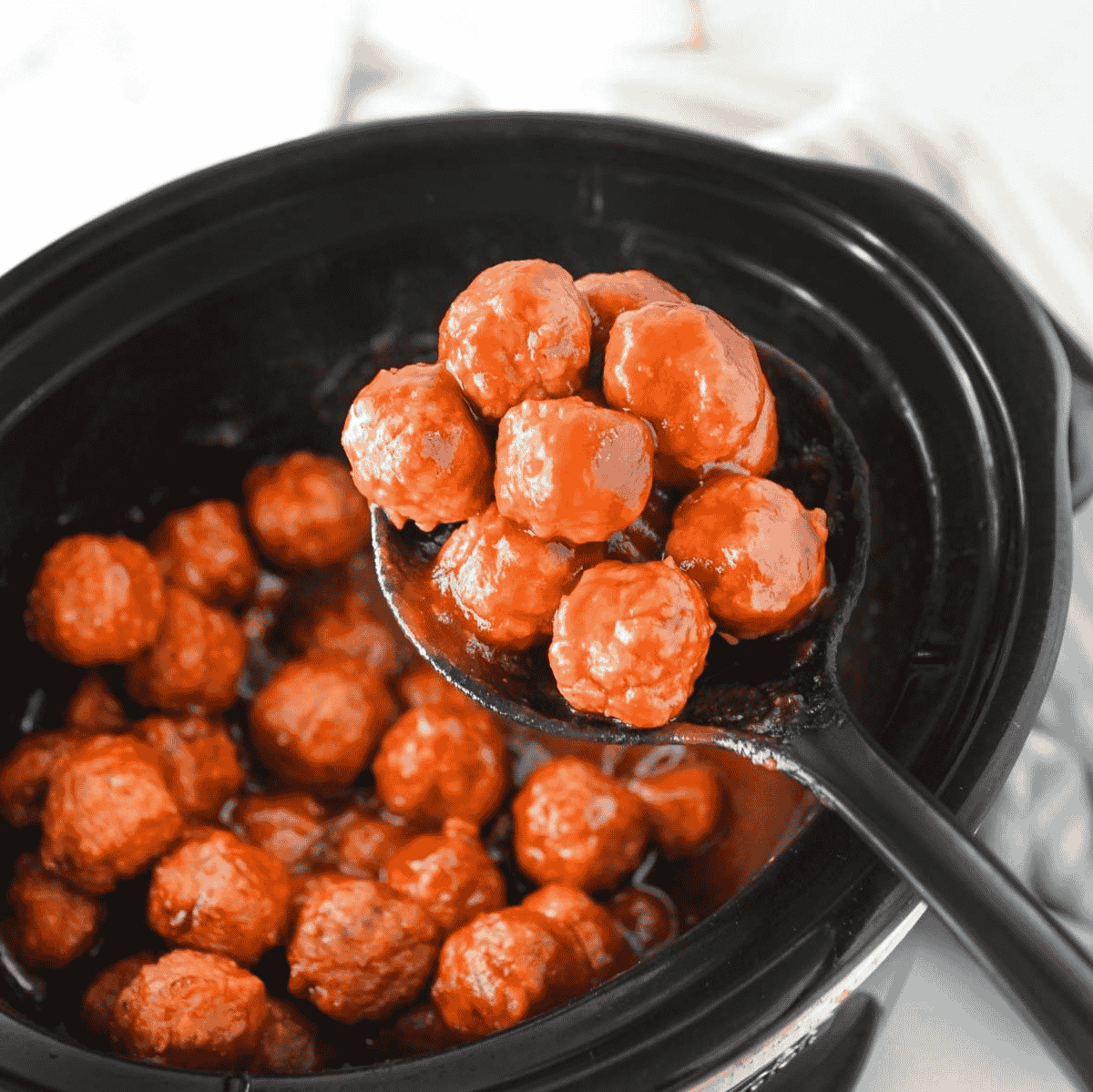 These Crock Pot Cranberry Meatballs are the easy party appetizer your holiday table needs. Frozen homestyle meatballs simmer in a sweet and tangy sauce made with chili sauce, jellied cranberry sauce, brown sugar and Worcestershire for a glossy, saucy bite that is perfect for Christmas appetizers, Thanksgiving party food, game day snacks, potlucks and easy slow cooker recipes. This dump and go crock pot meatballs recipe takes just 5 ingredients and minimal prep, making it a simple appetizer for parties, family gatherings or last minute entertaining. Serve these cranberry meatballs straight from the slow cooker with toothpicks for a warm, crowd pleasing appetizer everyone will keep coming back for.