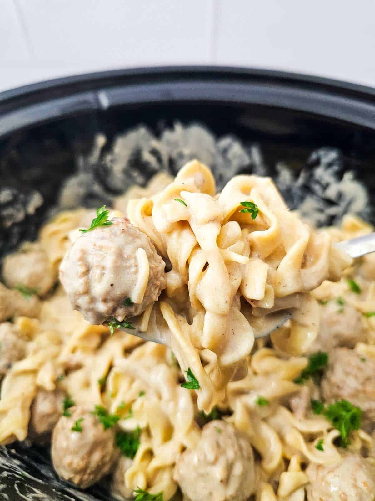 swedish meatballs and noodles on a spoon