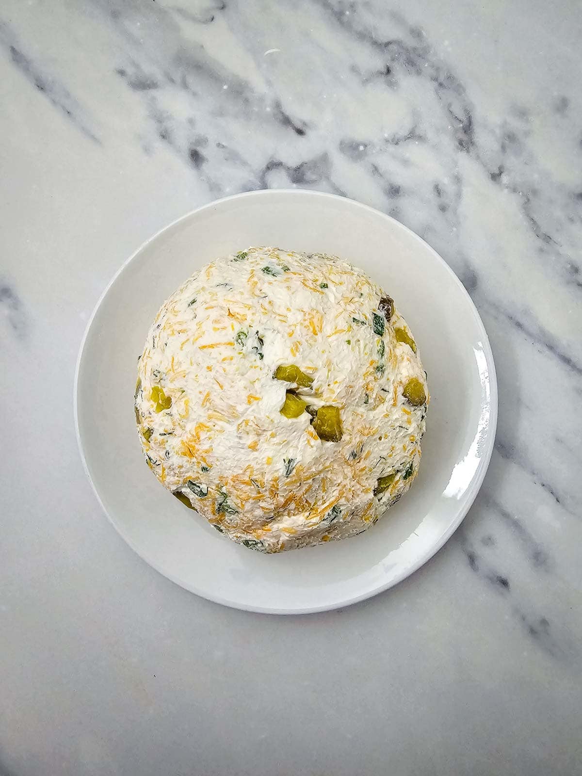 uncoated cheese ball on a plate