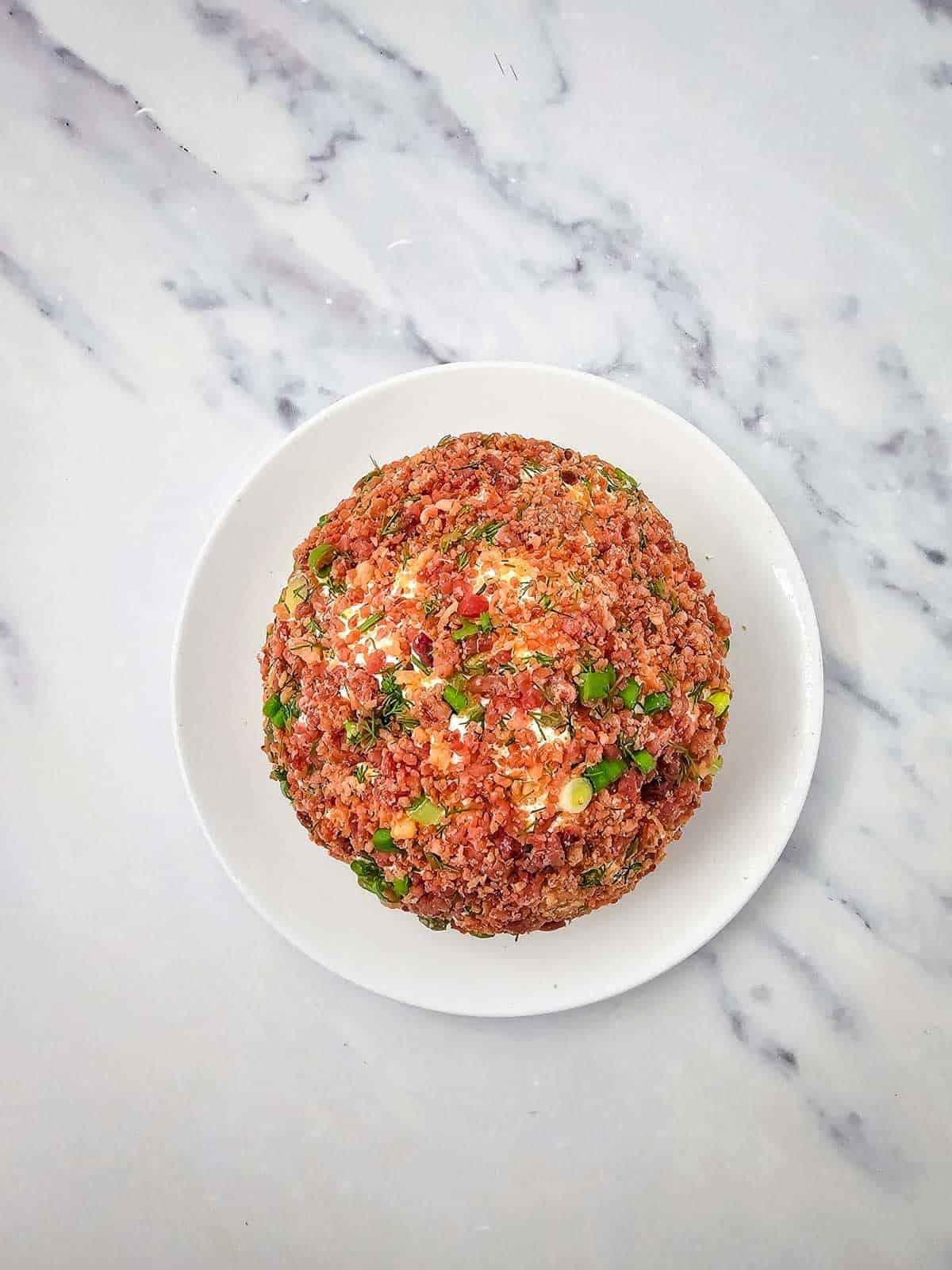bacon coated cheese ball on a plate