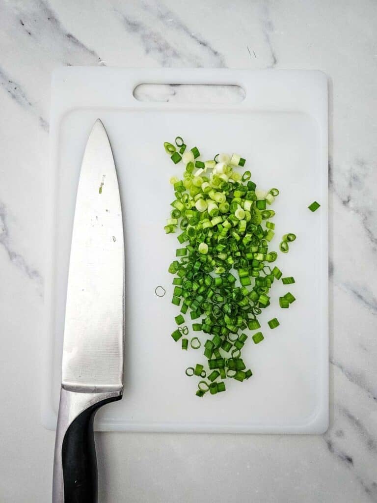 chopped green onions on a cutting board
