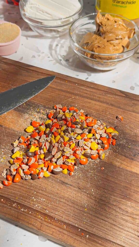 chopped Reese's pieces candies on a cutting board