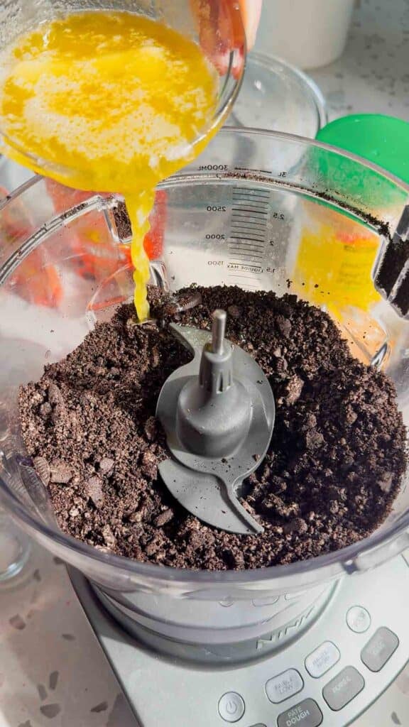 melted butter added to food processor with oreo crumbs