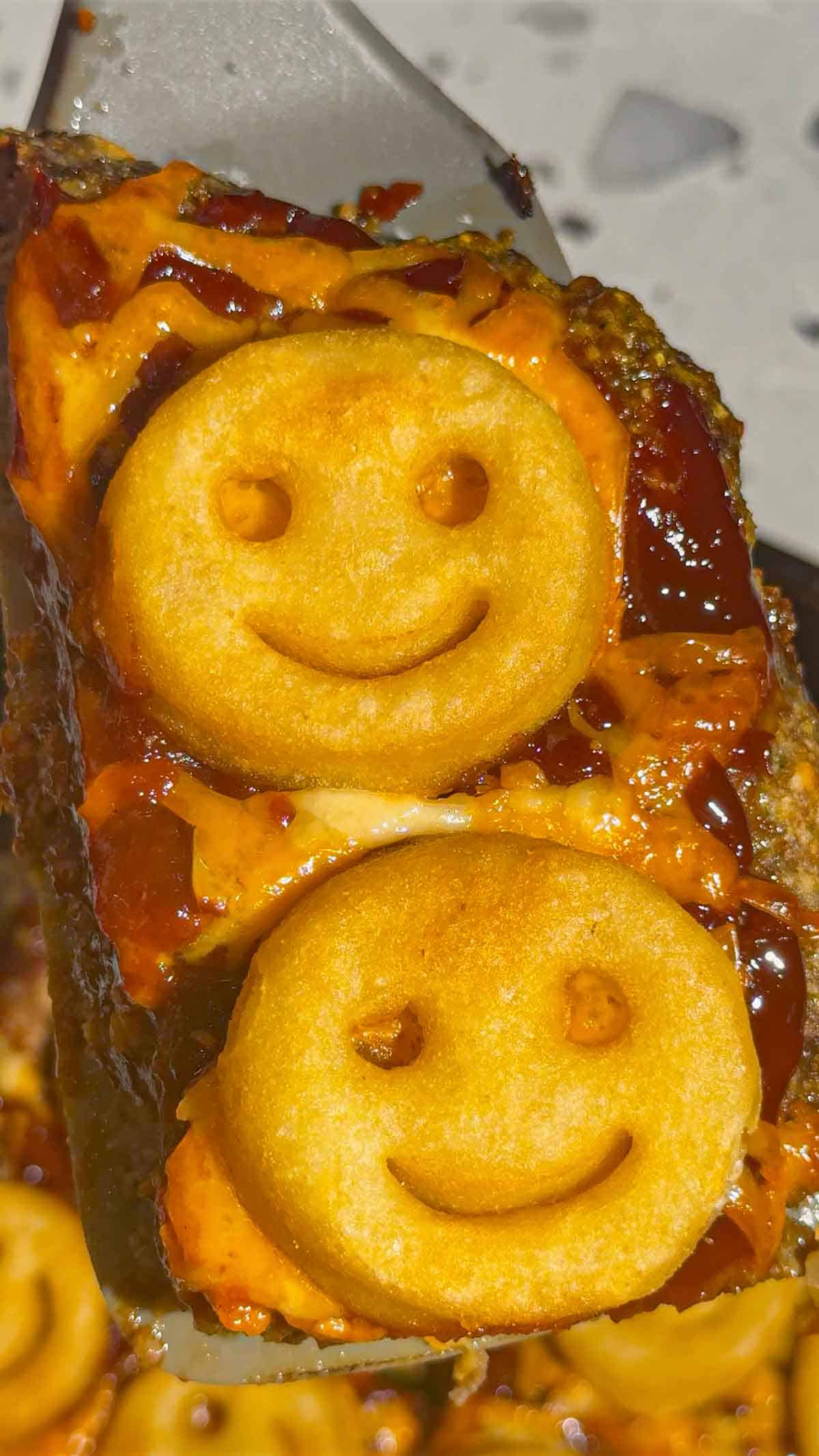 smiley face potatoes on top of sheet pan meatloaf