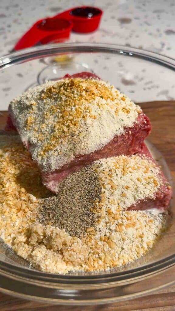minced onion, bread crumbs and raw ground beef in a glass bowl