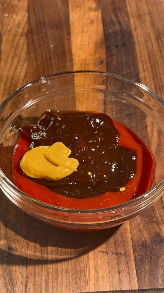 mustard, bbq sauce and ketchup in a glass bowl