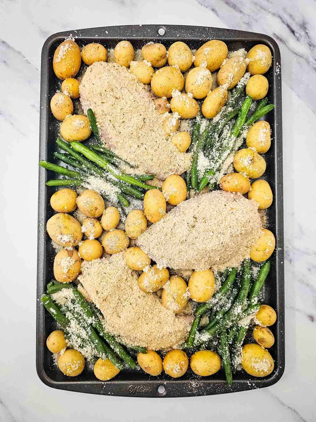 parmesan crusted chicken on a sheet pan before baking