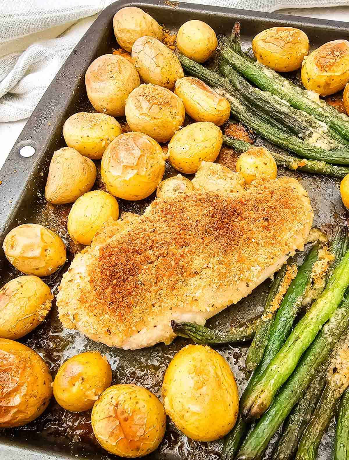 parmesan crusted chicken on a baking sheet