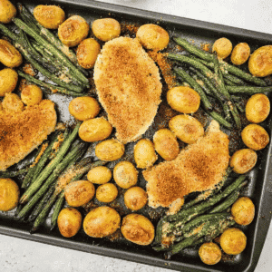 This Sheet Pan Parmesan Crusted Chicken is an easy weeknight dinner made with juicy chicken breasts, crispy Parmesan bread crumb topping, baby potatoes, and fresh green beans all roasted together on one pan. If you need simple chicken breast recipes, sheet pan dinners, one pan meals, easy family dinner ideas, or baked chicken recipes with vegetables, this hearty meal is a perfect choice. The Parmesan crust adds savory flavor and crunch while the potatoes turn tender and golden in the oven. This easy sheet pan chicken dinner is great for busy nights, meal planning, comfort food dinners, and simple recipes with minimal cleanup. Save this Parmesan chicken recipe for a cozy, fuss-free dinner everyone will love.