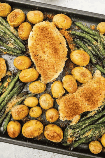 This Sheet Pan Parmesan Crusted Chicken is an easy weeknight dinner made with juicy chicken breasts, crispy Parmesan bread crumb topping, baby potatoes, and fresh green beans all roasted together on one pan. If you need simple chicken breast recipes, sheet pan dinners, one pan meals, easy family dinner ideas, or baked chicken recipes with vegetables, this hearty meal is a perfect choice. The Parmesan crust adds savory flavor and crunch while the potatoes turn tender and golden in the oven. This easy sheet pan chicken dinner is great for busy nights, meal planning, comfort food dinners, and simple recipes with minimal cleanup. Save this Parmesan chicken recipe for a cozy, fuss-free dinner everyone will love.