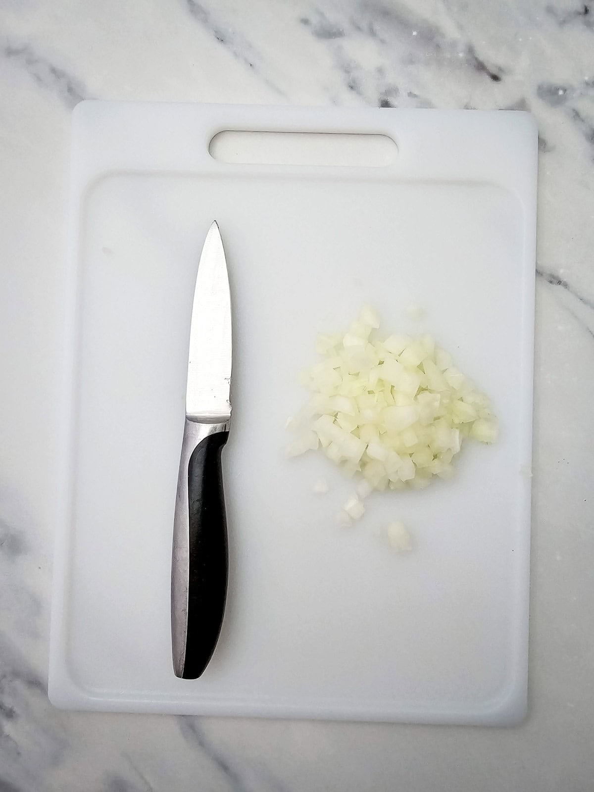 chopped onion on a cutting board