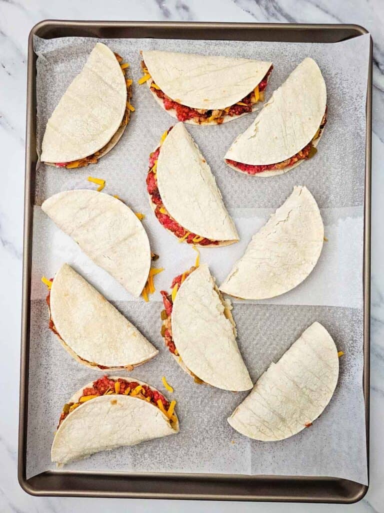 tacos on a sheet pan before baking