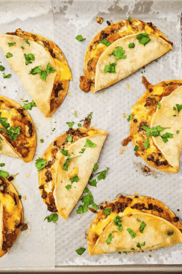 Sheet Pan Tacos are the easy taco night dinner you need when you want crispy, cheesy tacos without standing at the stove. These baked tacos are made with corn tortillas, seasoned ground beef, diced green chiles, refried beans, and sharp cheddar cheese, then baked on sheet pans until golden and crunchy. Perfect for busy weeknights, game day food, party dinners, family meals, or feeding a crowd, this simple sheet pan taco recipe keeps prep easy and cleanup minimal. Serve with sour cream, salsa, avocado, tomatoes, cilantro, or your favorite taco toppings for a fun dinner everyone can customize. If you love easy ground beef recipes, crispy tacos, baked tacos, and family friendly Mexican-inspired dinners, this recipe belongs on your menu.