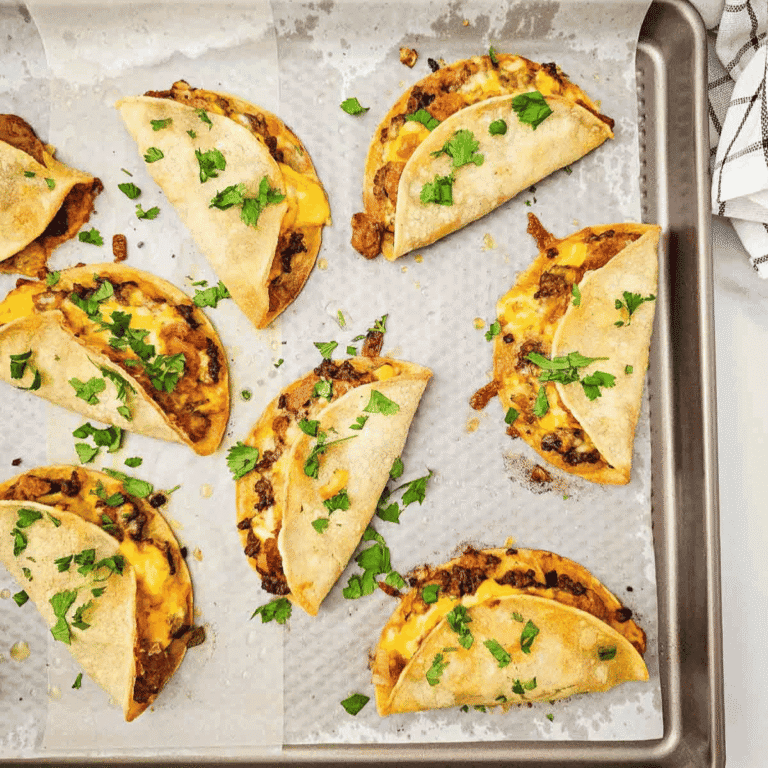 Sheet Pan Tacos are the easy taco night dinner you need when you want crispy, cheesy tacos without standing at the stove. These baked tacos are made with corn tortillas, seasoned ground beef, diced green chiles, refried beans, and sharp cheddar cheese, then baked on sheet pans until golden and crunchy. Perfect for busy weeknights, game day food, party dinners, family meals, or feeding a crowd, this simple sheet pan taco recipe keeps prep easy and cleanup minimal. Serve with sour cream, salsa, avocado, tomatoes, cilantro, or your favorite taco toppings for a fun dinner everyone can customize. If you love easy ground beef recipes, crispy tacos, baked tacos, and family friendly Mexican-inspired dinners, this recipe belongs on your menu.
