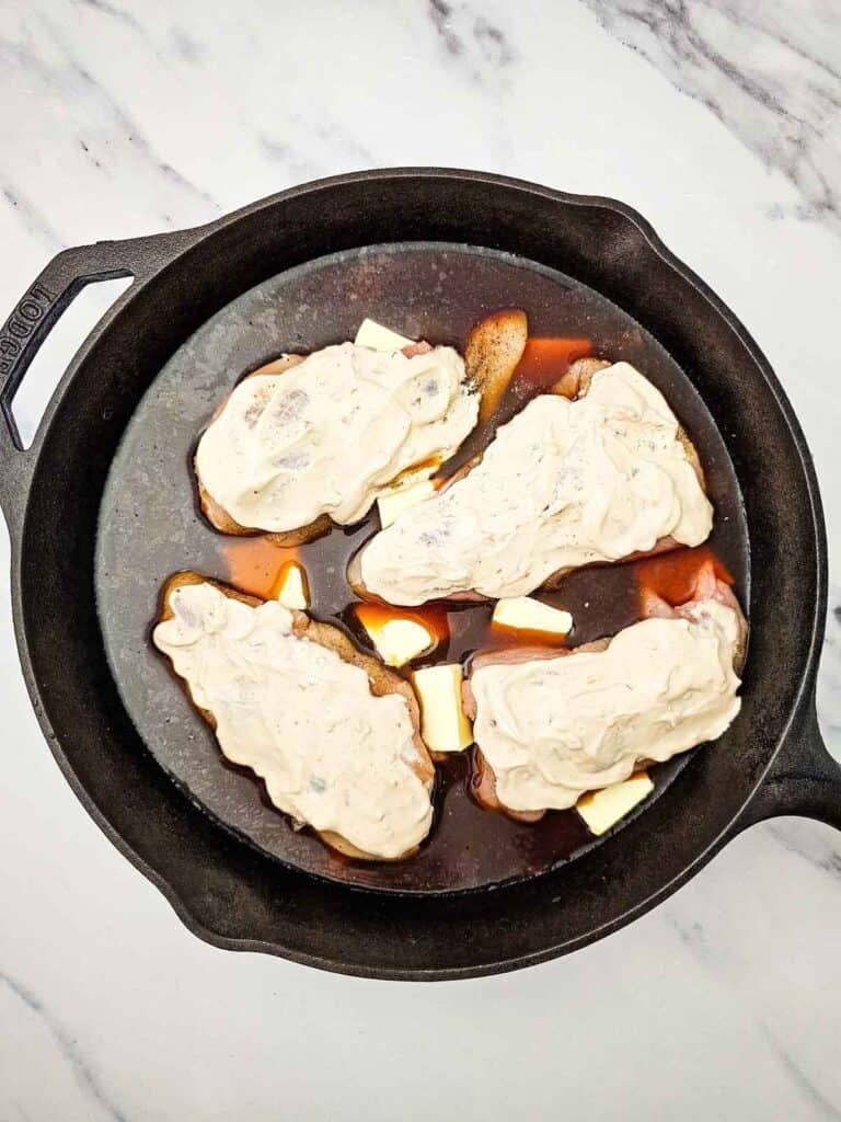 sour cream and onion soup mix spread over chicken breasts in the skillet